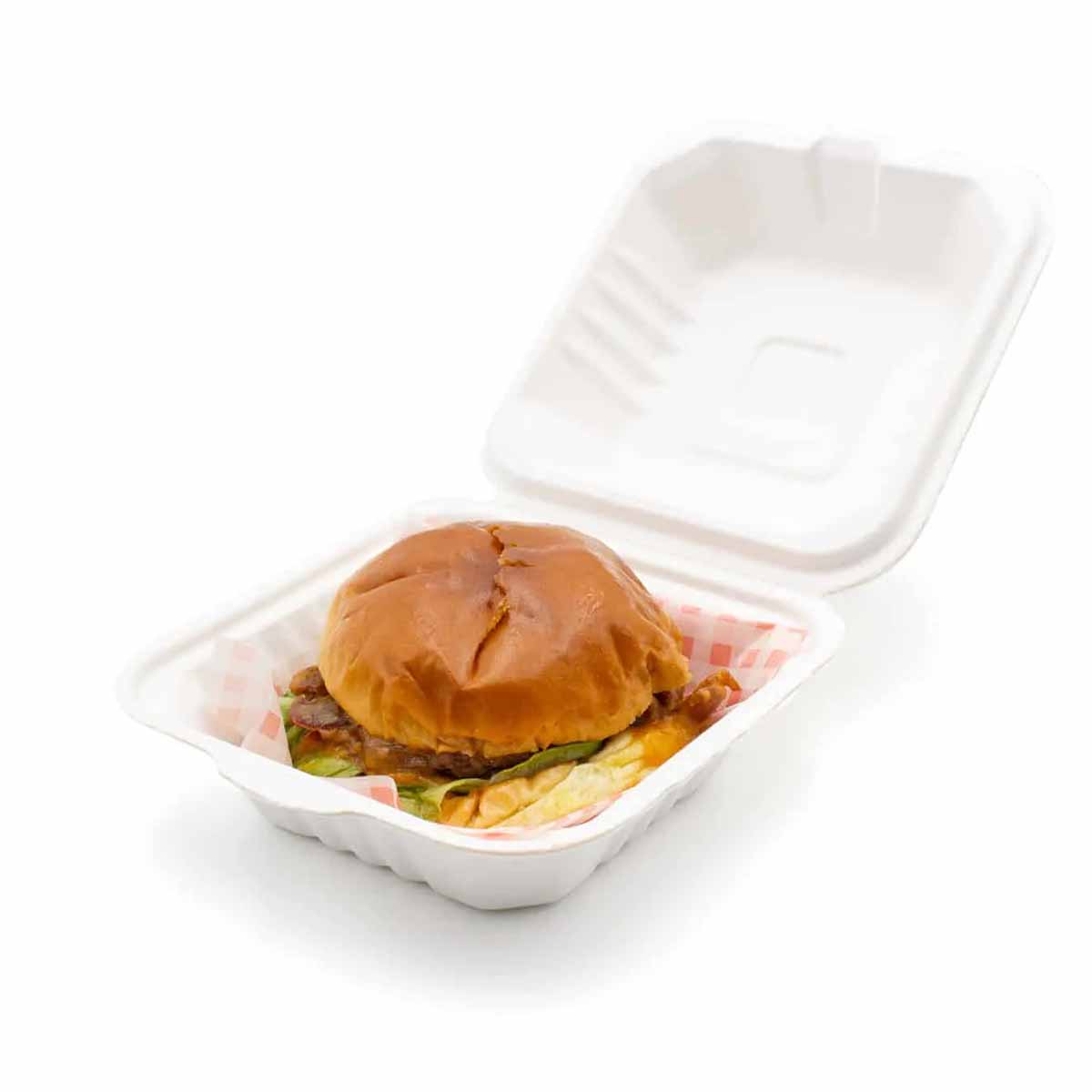 A stack of bagasse burger boxes in a custom size
