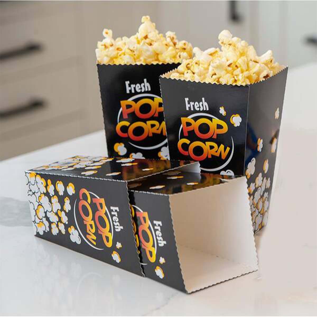 Popcorn Boxes — custom popcorn boxes by Packmio Popcorn Boxes beside the product it was made to hold