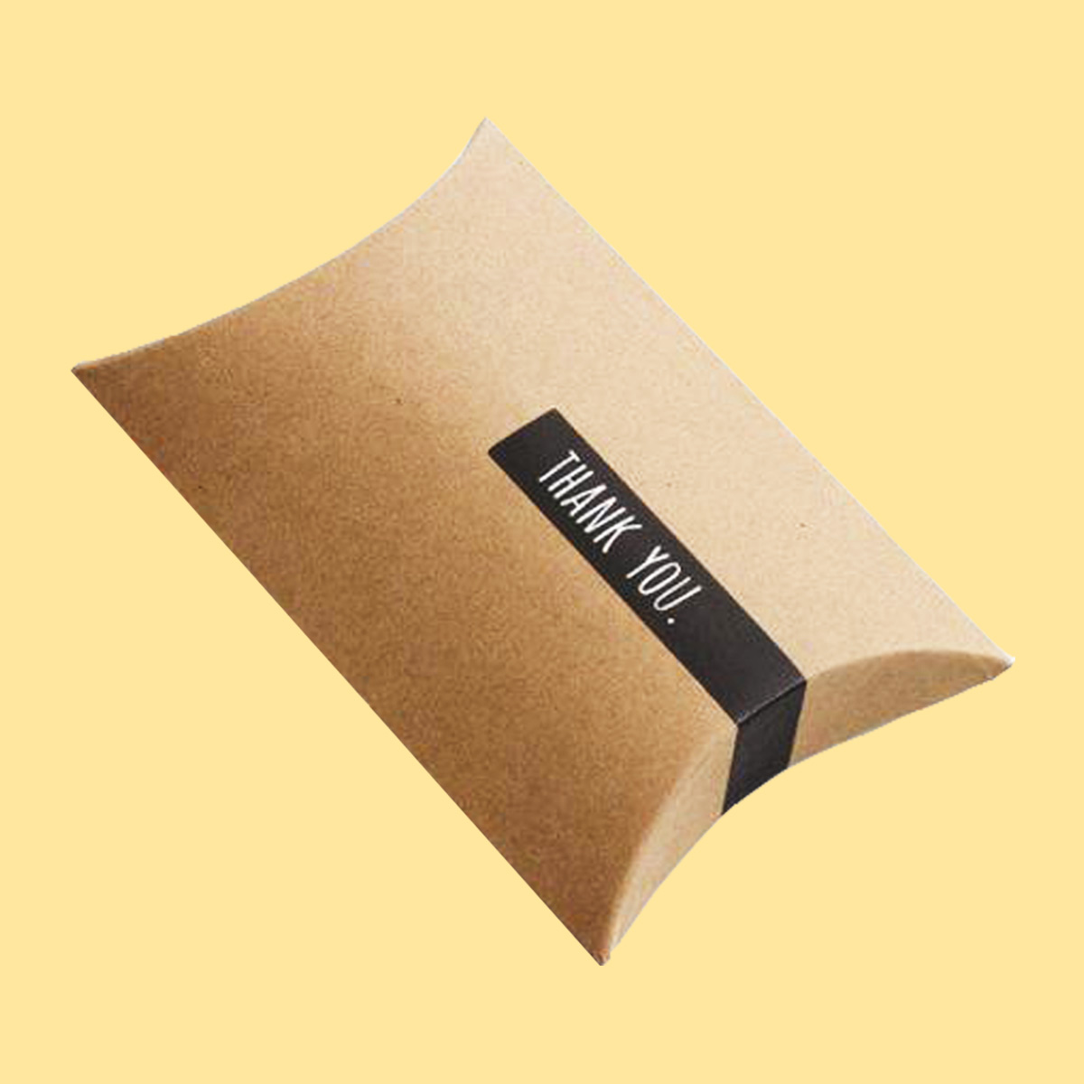 Kraft Pillow Boxes photographed at an angle to show the board thickness