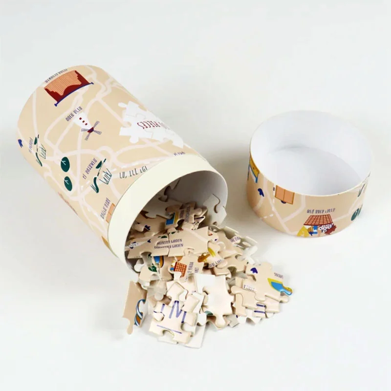 Paperboard Tube Packaging Puzzle — custom game boxes by Packmio Paperboard Tube Packaging Puzzle beside the product it was made to hold