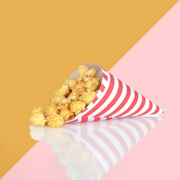 Popcorn Paper Cones beside the product it was made to hold