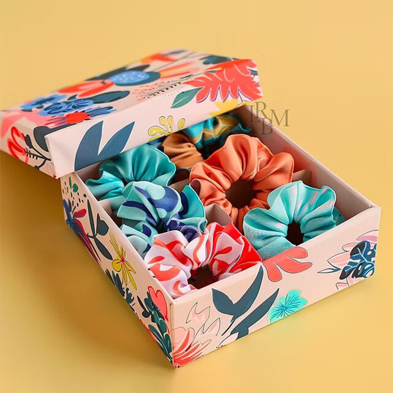 Scrunchie Boxes — custom apparel boxes by Packmio Scrunchie Boxes photographed at an angle to show the board thickness